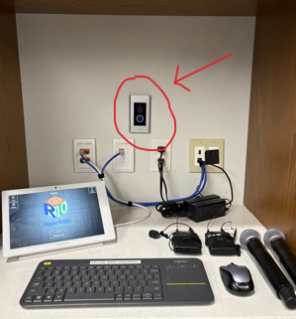 Ring doorbell located in the conference room cabinet where the equipment and keyboard are located